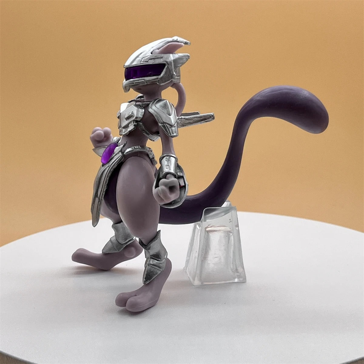 Animated character with a futuristic design on a white platform with a beige background